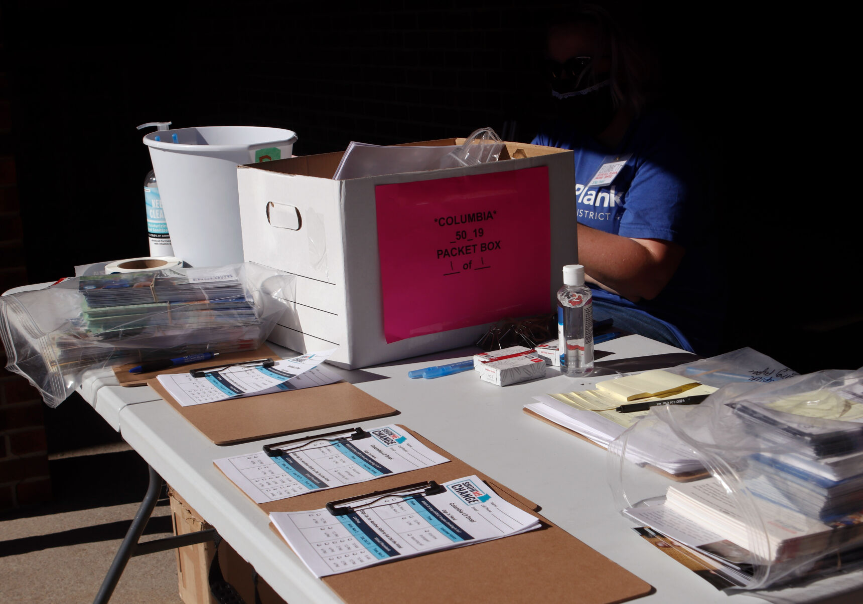 Elisabeth Condon helps volunteers sign up to drop off literature to target voters